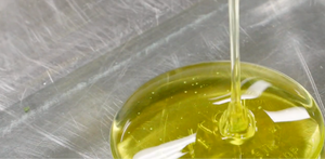 Refined oil being poured into a metallic surface